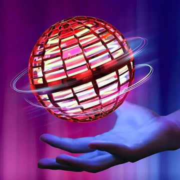Hand holding colorful Flying Ball Toy drone ball with LED lights against purple background in Pakistan