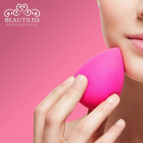 Hand holding pink beauty blender in Pakistan